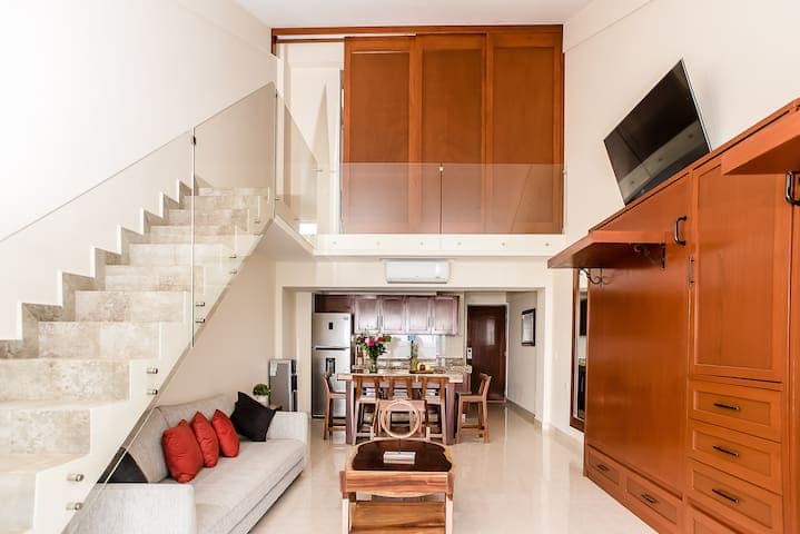 View from living room looking up to the second bedroom. Large sliding doors separate the space for privacy.