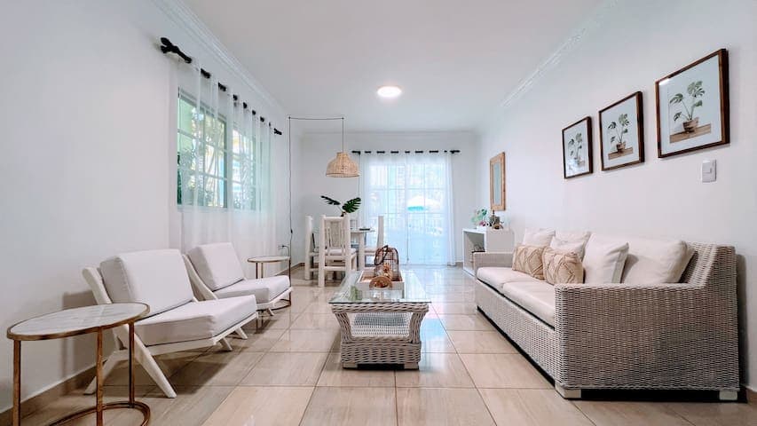 Open concept living, dining space with pool view and a comfy sofa bed for friends and family.