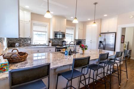 Seating for five at the granite counters (plus 12 at the dining table). Spacious kitchen can accommodate the chef and helpers!