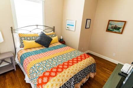 This queen bedroom is on the top floor, next to the kitchen, and has it's own little sunny balcony.