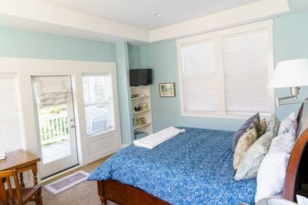 Master bedroom on main floor has a king bed, big deck, and full bathroom.