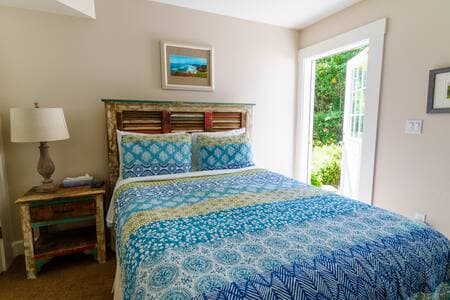 This queen bedroom/full bathroom suite has its own entrance. It is at the ground level of the ADU building just next to the house, and is accessed by an exterior stairway that is between the buildings.