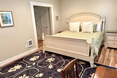 This king bedroom/full bathroom suite has its own entrance, at the ground level, down a flight of external stairs on the side of the house. The hot tub is on the patio outside.