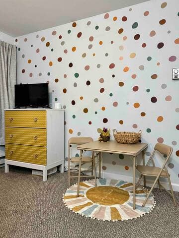 The kids room has a Roku Smart TV and play table & chairs. The table and chairs easily fold away if more space is needed for the travel crib or toddler bed