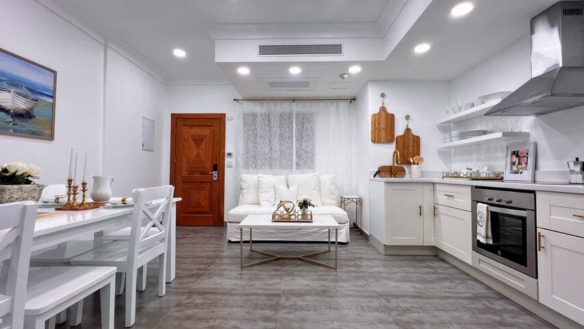 Common living space featuring full kitchen, sitting, and dining areas.