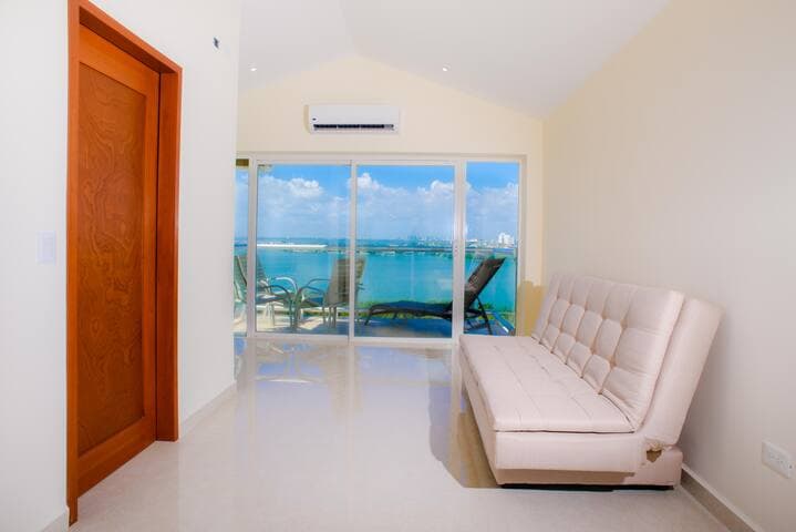 Downstairs sitting area that transforms into a bedroom by closing three sliding doors. Futon sleeps 2 comfortably. Full size bathroom and balcony.
