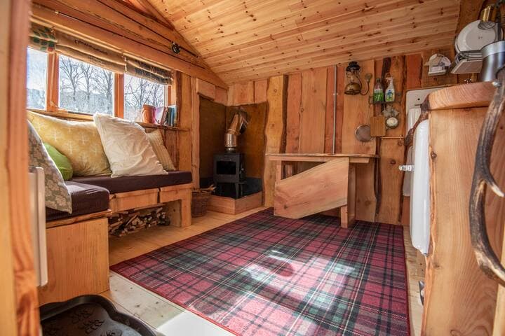 All our Bothies have Douglas Fir waney-edged boards inside and out. Even the windows are hand-made. The furniture and tables inside the Bothies were all made to our design. They all have an electric wall heater, wood stove and sheep wool insulation