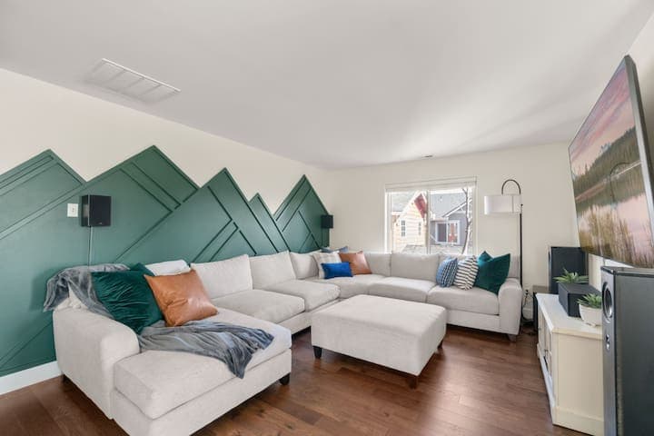 Movie theater in the mountains on the second story of the house with a giant TV.