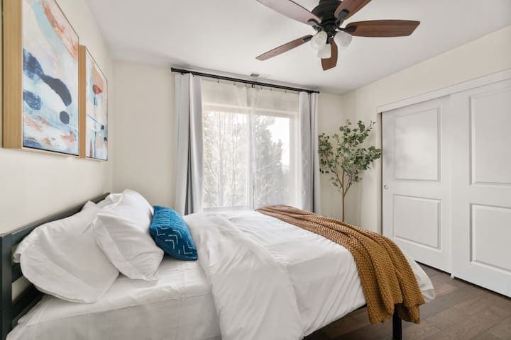 Luxury queen bed with memory phone mattress and soft bedding.