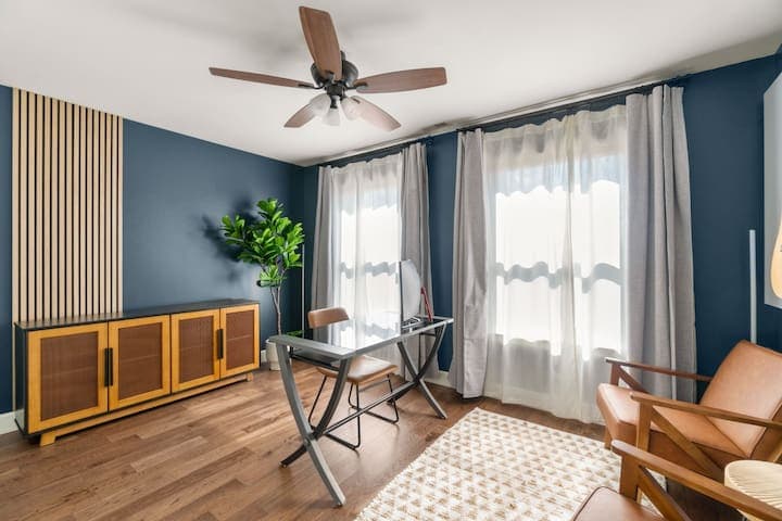 Working remote or creating content is easy in this dedicated office space with a large curved monitor.