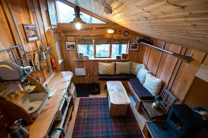 View from Glenaladale's top double bed, looking down on the seating area and kitchen area