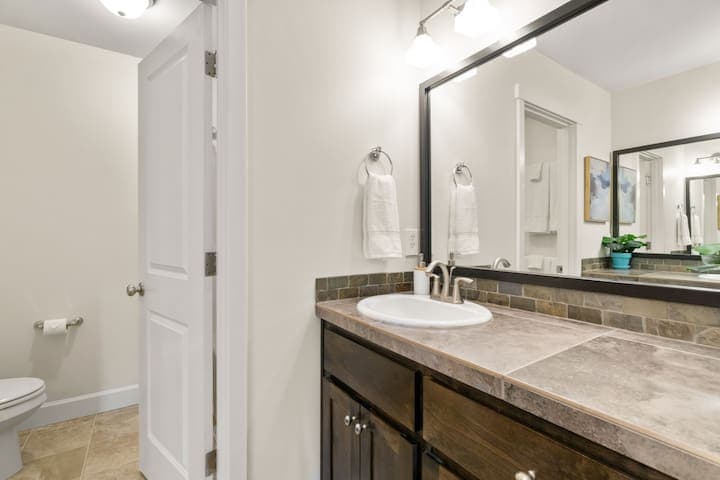This upstairs bathroom has two vanities and two sinks.