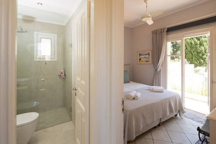 Bedroom 3 on the upper level with the adjacent bathroom