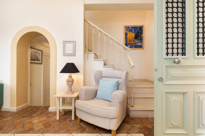 The main entrance to the villa. The staircase to the upper level is seen behind the open door. On the left the 2-step down to the Bedroom 1, kitchen and bathroom.