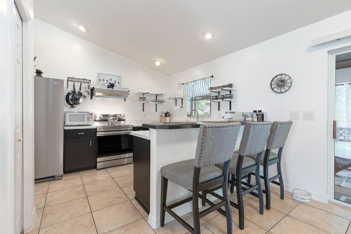 Newly updated kitchen with open shelving, and all new appliances including a dishwasher. Seating for 3 at the breakfast bar.