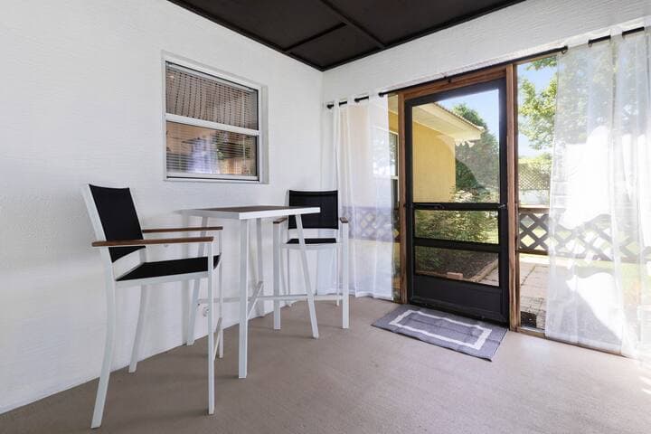 Outdoor dining for two just below the kitchen window.