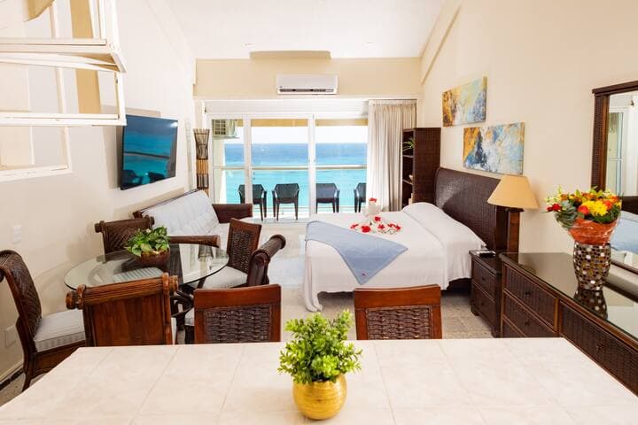 Downstairs living/sleeping area with balcony overlooking the ocean and beach.