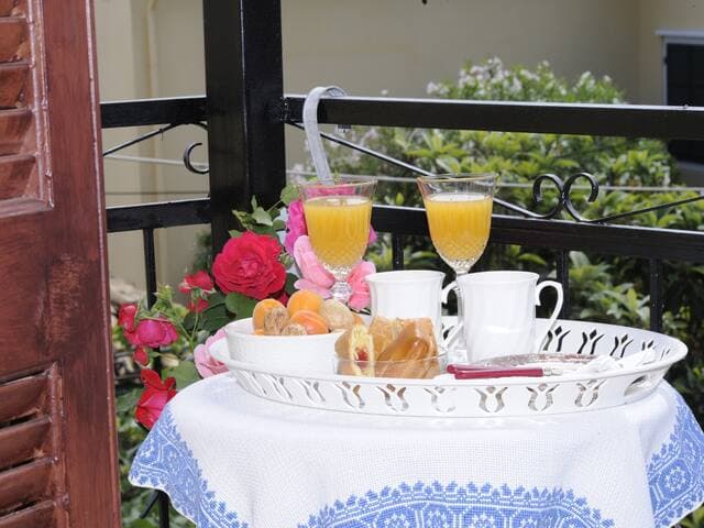 Master bedroom balcony with views towards the village square with an ouzo table and chairs