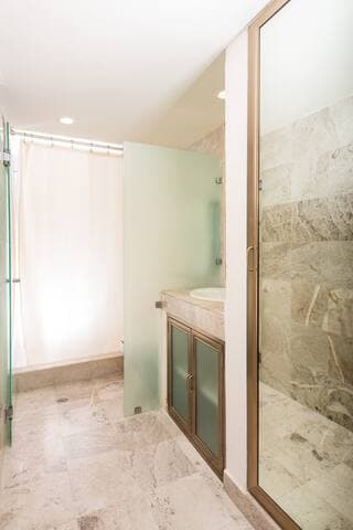 Downstairs bathroom. Full length mirror, shower and vanity.