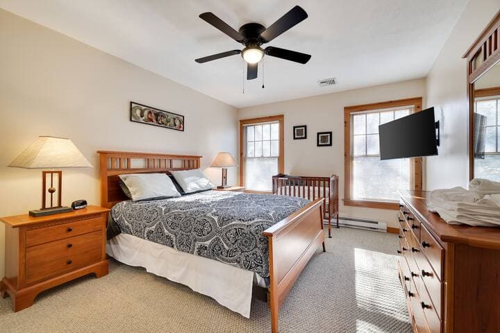Second floor bedroom with queen bed and crib.