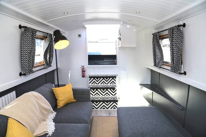 View of the living area and rear door showing the sofa bed on the left side.